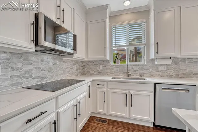 a very nice looking room with a kitchen island hardwood floor and a ceiling fan