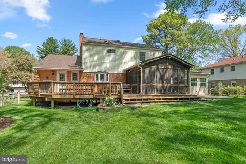 a view of a house with a yard deck and sitting area