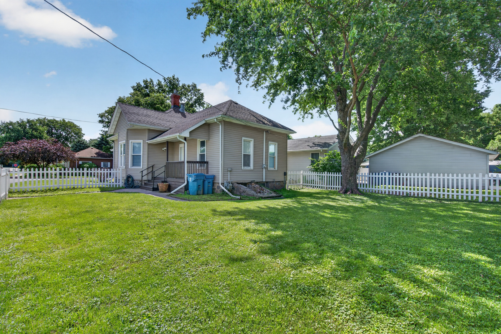 1128 Butler Street Morris, IL 60450 - Photo 25 of 28 a view of a house with a big yard potted plants and large tree