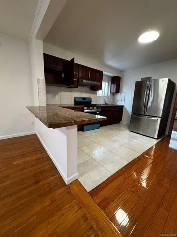 a kitchen with stainless steel appliances granite countertop a sink and a stove