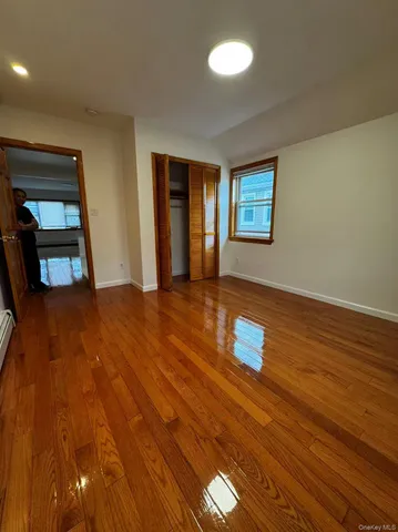 a room with wooden floor and window