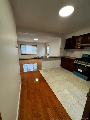 a large kitchen with stainless steel appliances granite countertop a stove a sink and a microwave