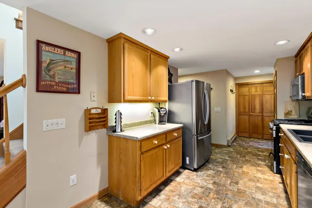 a kitchen with a refrigerator stove and sink