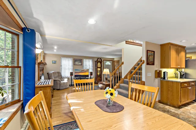 a view of a dining room with furniture a chandelier and wooden floor