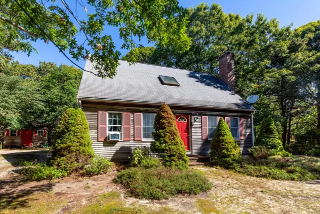 a front view of house with a garden