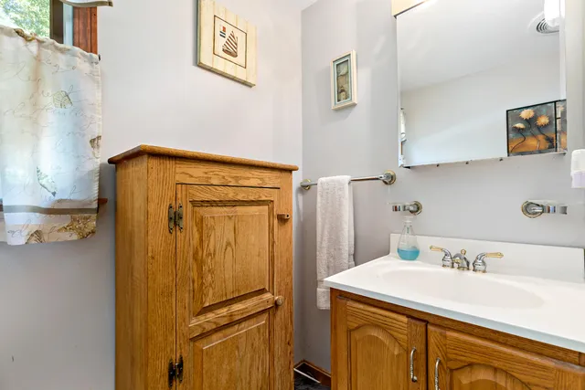 a bathroom with a sink a mirror and a shower