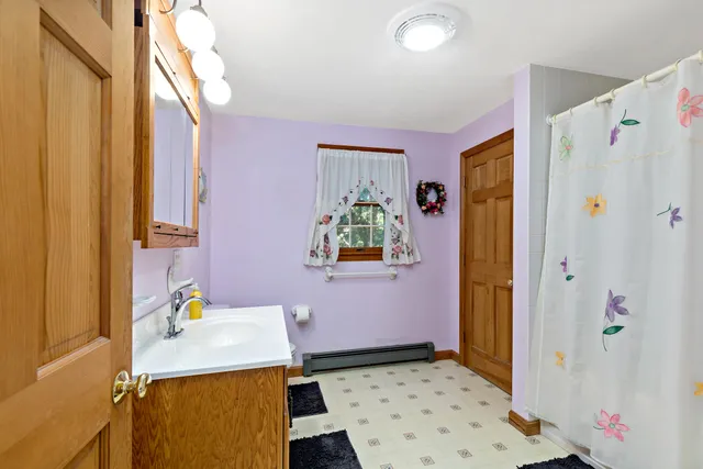 a view of a dining room with furniture a chandelier and wooden floor