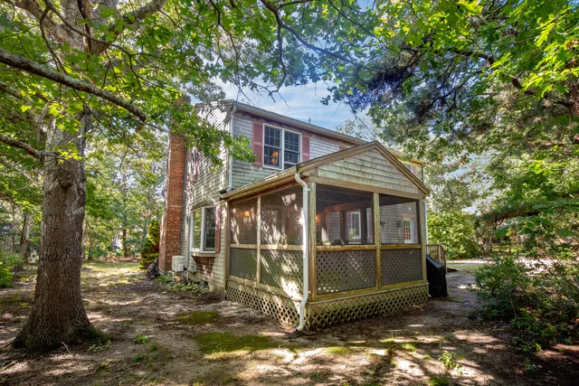 a view of a small house in the forest