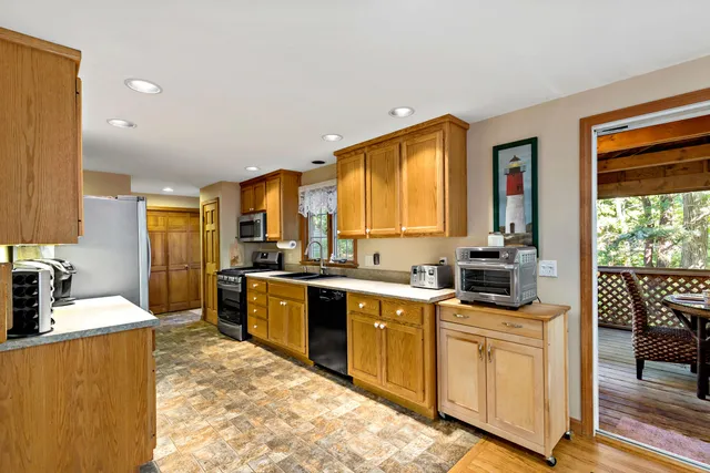 a kitchen with stainless steel appliances granite countertop sink stove and refrigerator