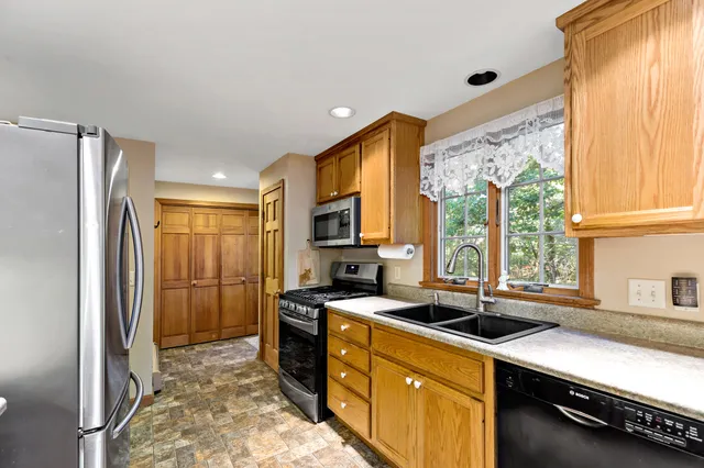 a kitchen with stainless steel appliances a sink stove and refrigerator