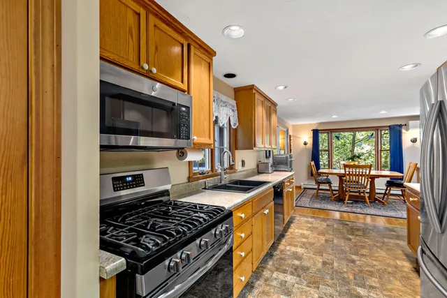 a kitchen with stainless steel appliances granite countertop a stove and a sink