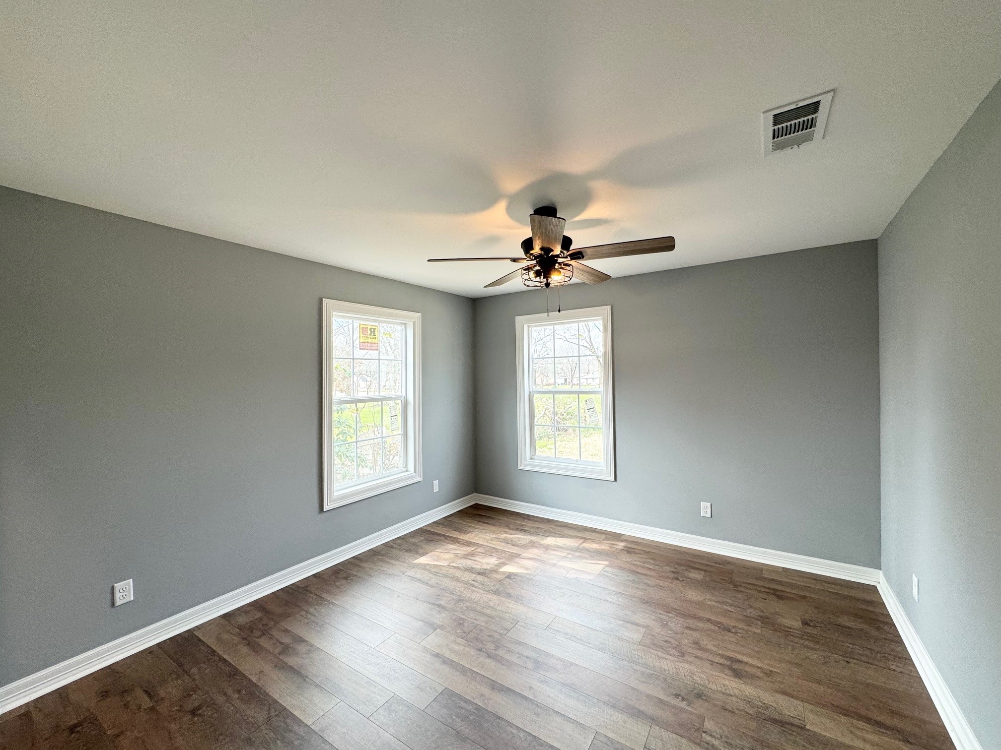 409 South 9th Street Crockett, TX 75835 - Photo 15 of 19 a view of an empty room with a window and wooden floor