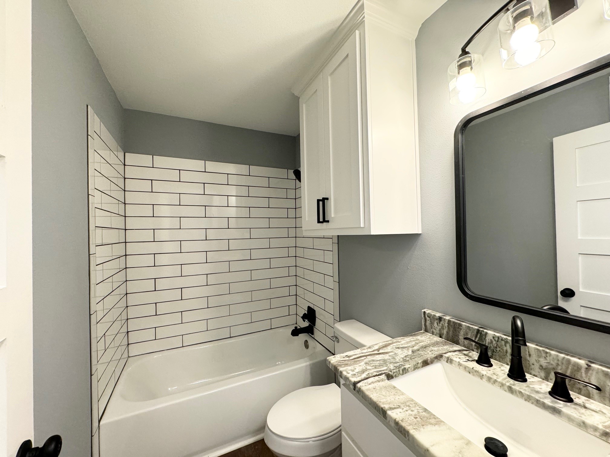 409 South 9th Street Crockett, TX 75835 - Photo 16 of 19 a bathroom with a sink toilet and shower