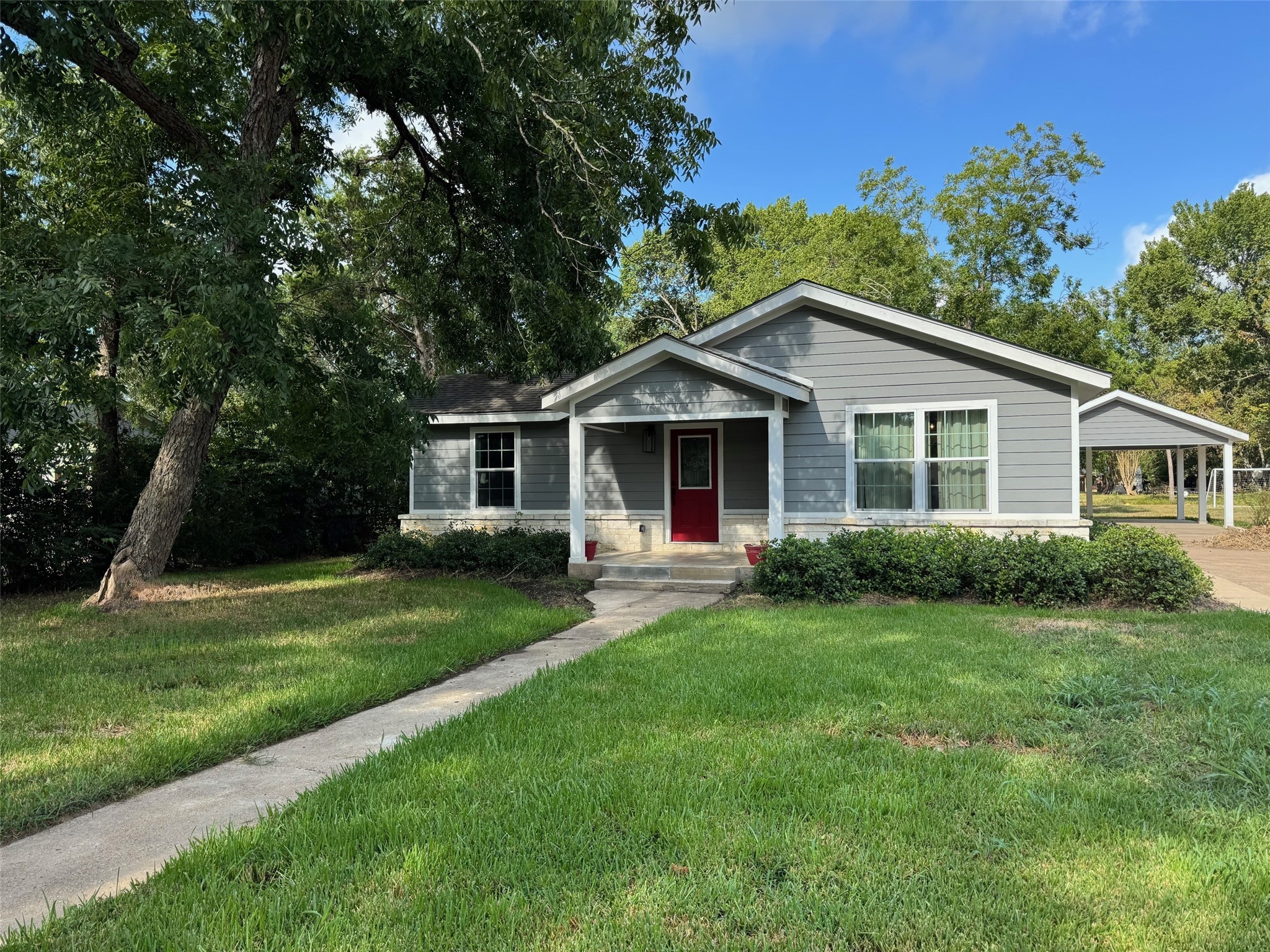 409 South 9th Street Crockett, TX 75835 - Photo 19 of 19 a front view of a house with a yard and trees