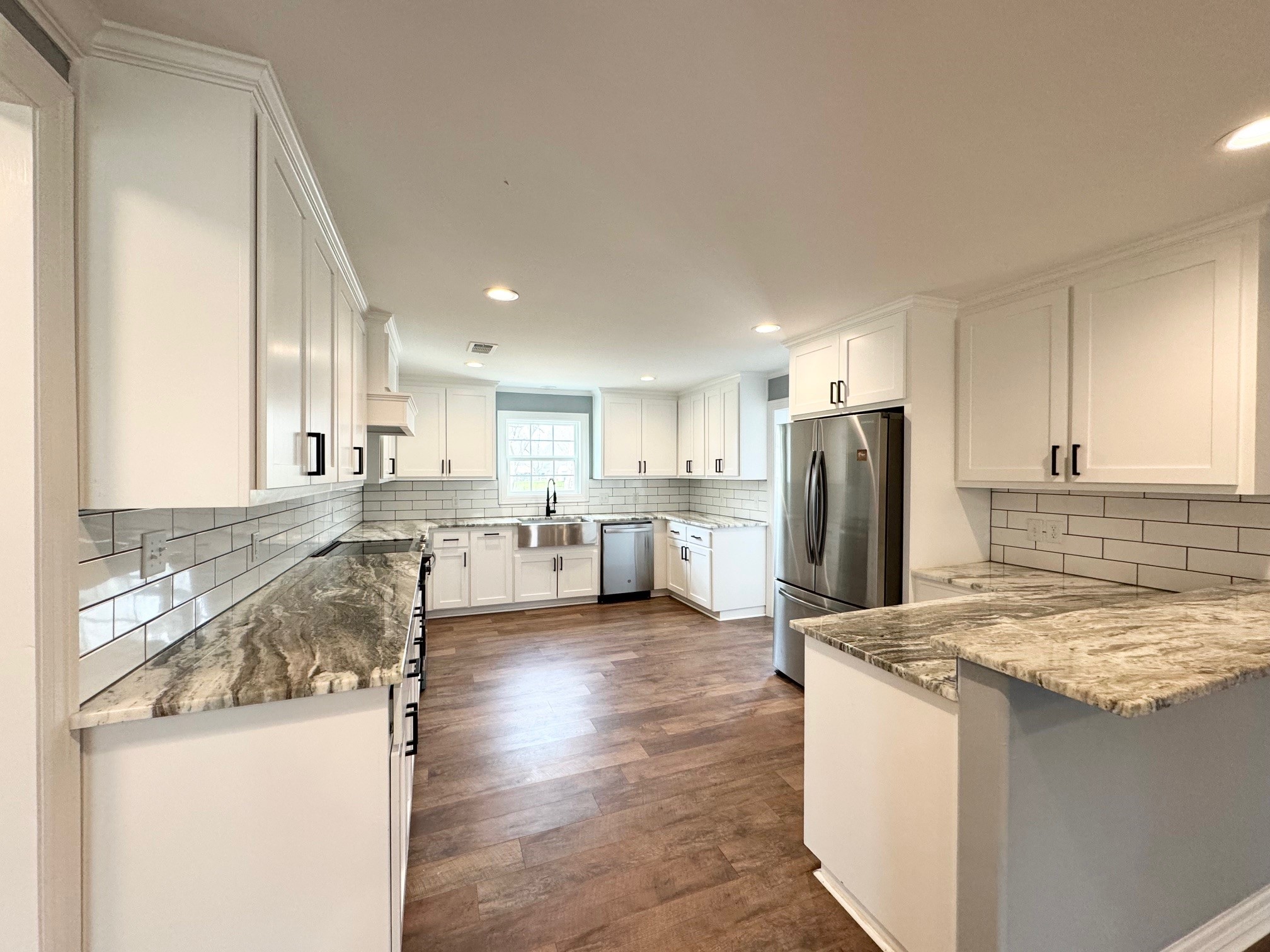409 South 9th Street Crockett, TX 75835 - Photo 5 of 19 a kitchen with stainless steel appliances granite countertop a refrigerator a stove and a sink