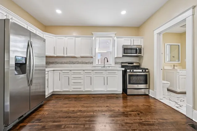 a kitchen with stainless steel appliances a refrigerator stove and microwave