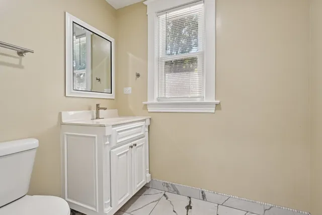 a bathroom with a sink toilet and vanity