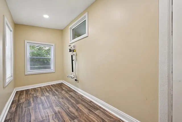 a view of a room with wooden floor and window