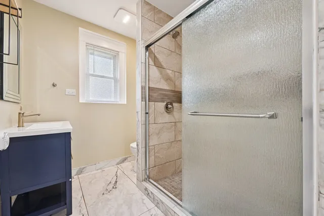 a bathroom with a shower and a sink