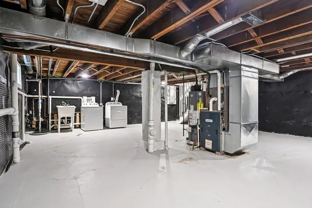 a view of water heater room with refrigerator
