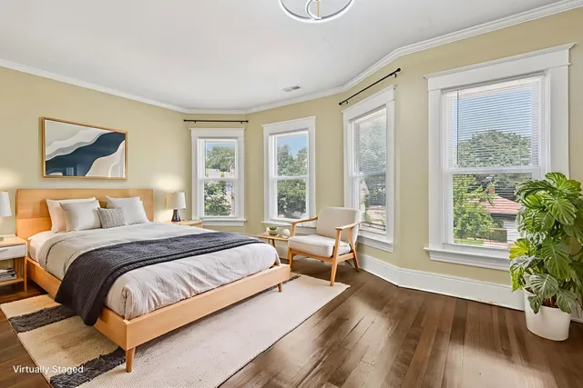 a spacious bedroom with a bed and a large window