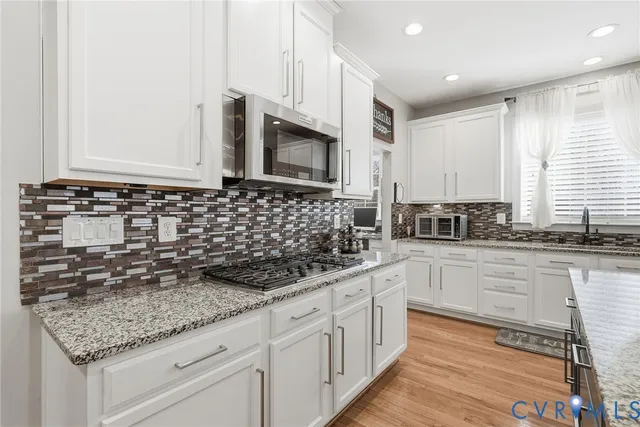 a table with a computer on a desk and chair