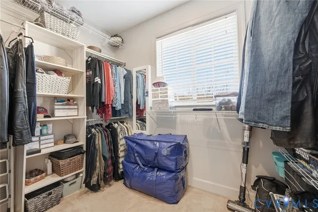 a spacious bedroom with a bed and a chandelier