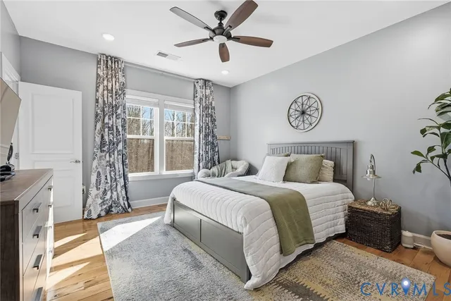 a bedroom with a large bed and a flat screen tv