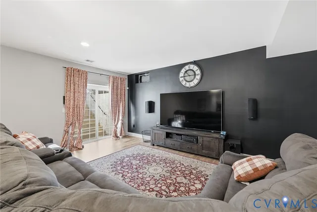 a living room with a bed furniture and a window
