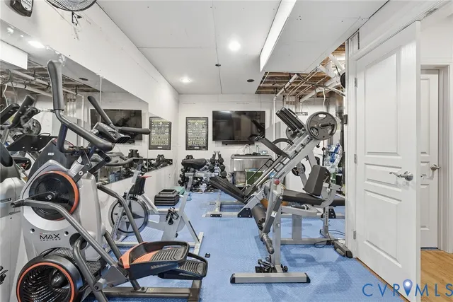 a view of a big house with a big yard and large trees