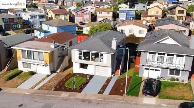 an aerial view of residential houses with street
