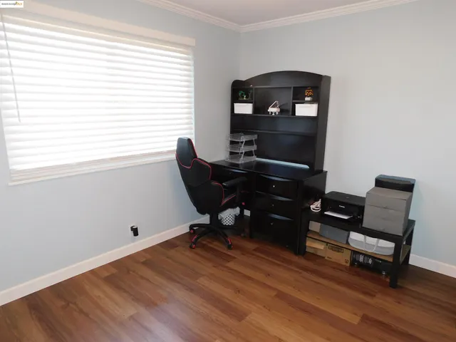 a large bed sitting in a bedroom next to a window