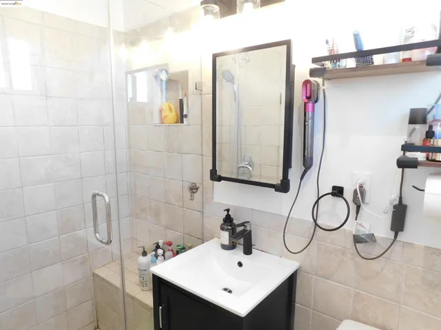 a view of a hallway with a room and a bathroom