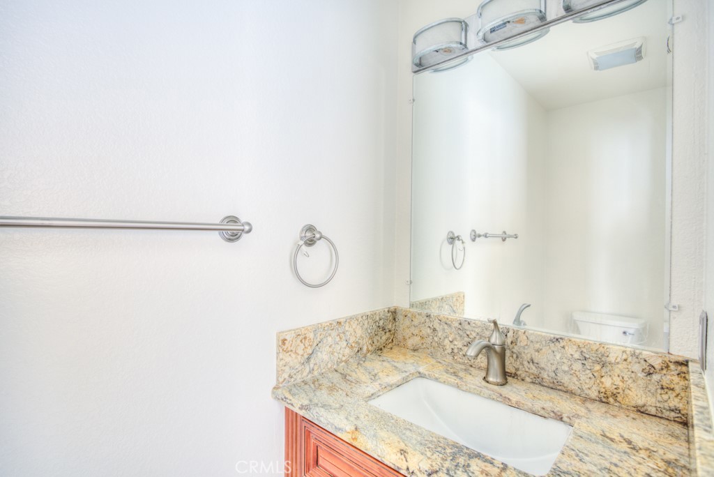 13006 Parkview Drive Baldwin Park, CA 91706 - Photo 15 of 46 a bathroom with a granite countertop sink and a mirror