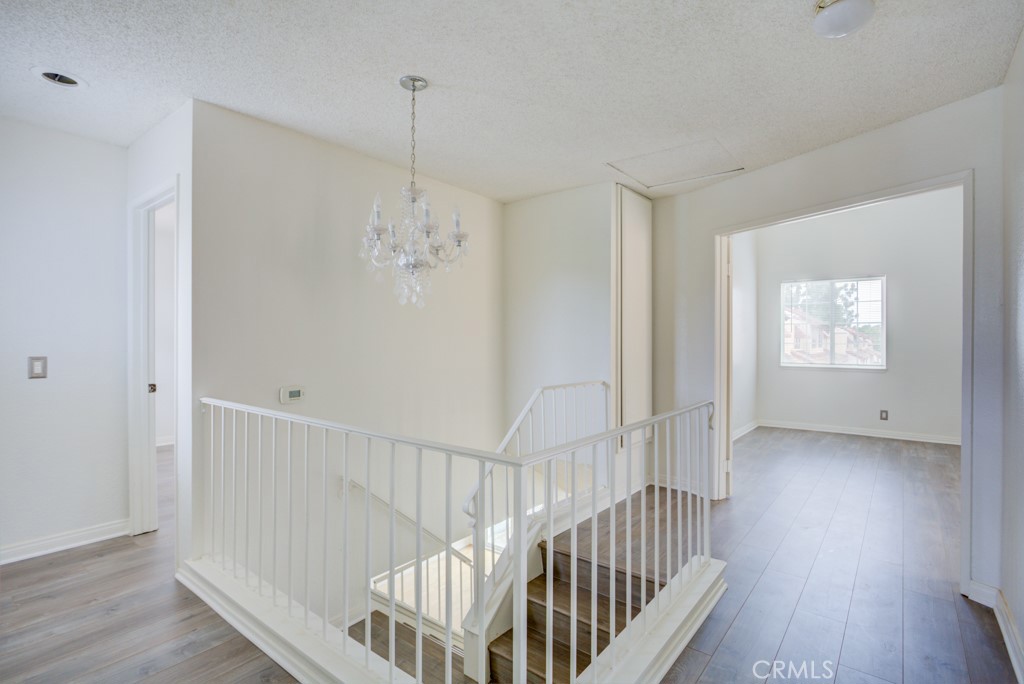 13006 Parkview Drive Baldwin Park, CA 91706 - Photo 18 of 46 a view of a hallway with wooden floor and windows