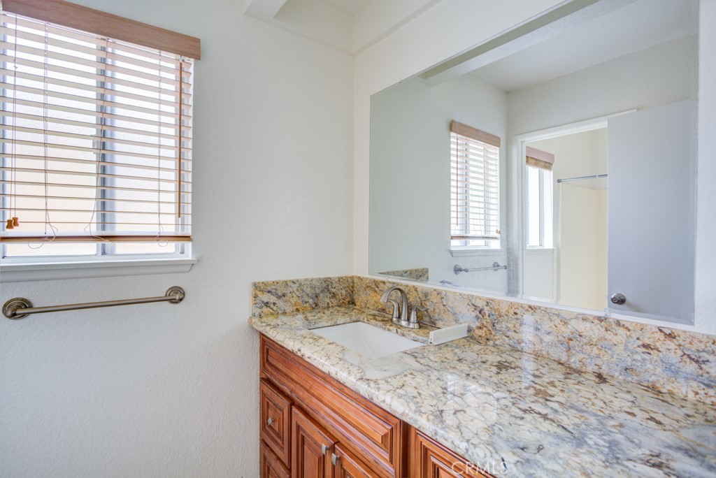 13006 Parkview Drive Baldwin Park, CA 91706 - Photo 23 of 46 a bathroom with a granite countertop sink and a window