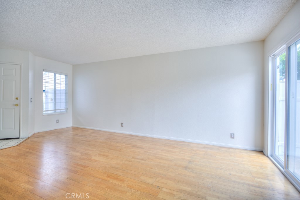 13006 Parkview Drive Baldwin Park, CA 91706 - Photo 3 of 46 a view of an empty room with wooden floor and windows