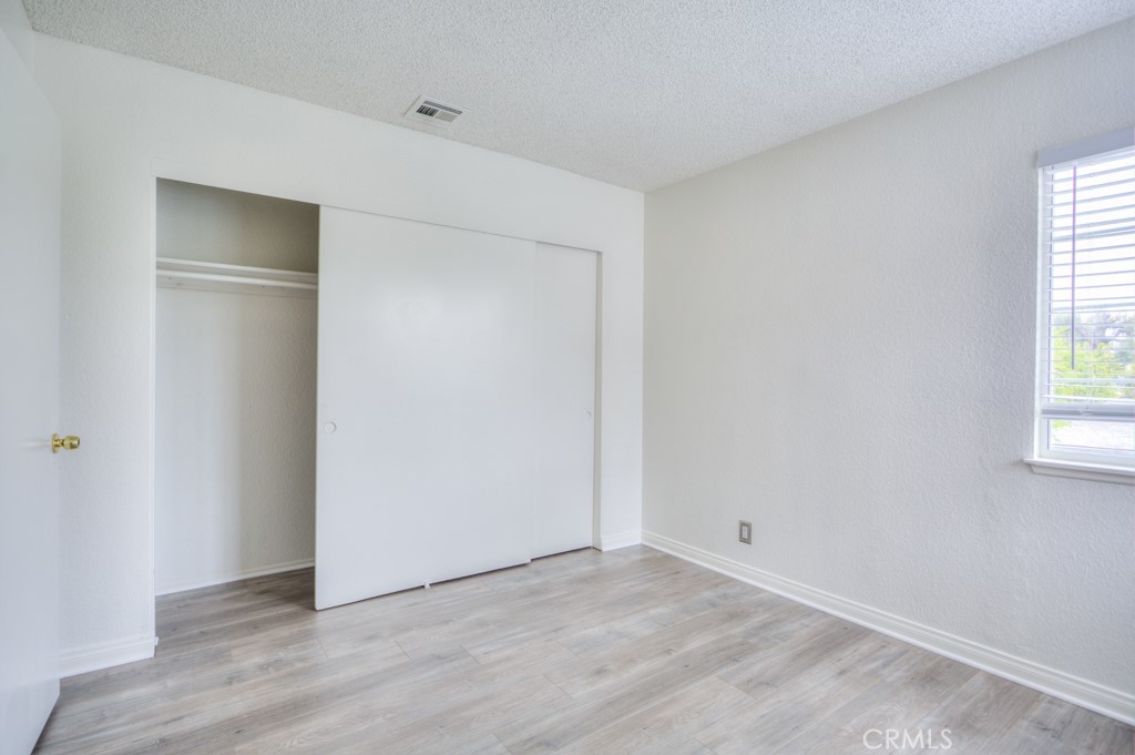 13006 Parkview Drive Baldwin Park, CA 91706 - Photo 34 of 46 a view of an empty room with wooden floor and a window