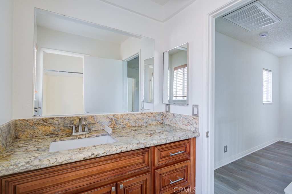 13006 Parkview Drive Baldwin Park, CA 91706 - Photo 36 of 46 a bathroom with a granite countertop sink and a mirror