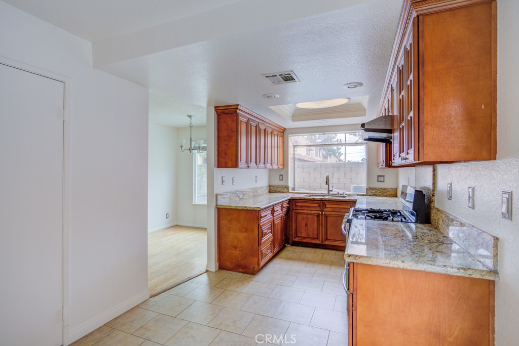 13006 Parkview Drive Baldwin Park, CA 91706 - Photo 6 of 46 a kitchen with granite countertop a sink and a stove top oven