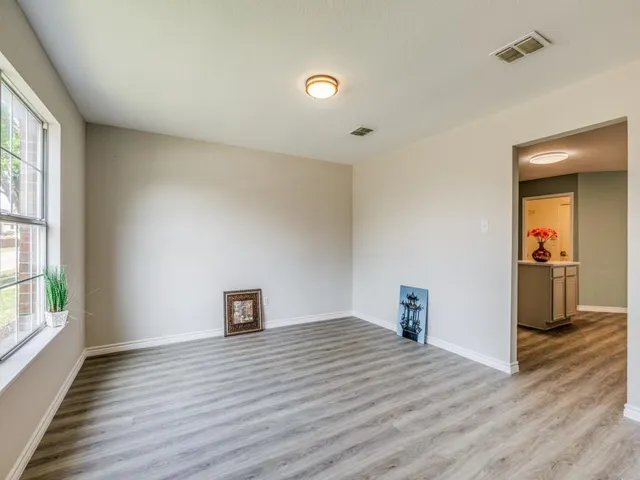 a view of a livingroom with wooden floor and a window
