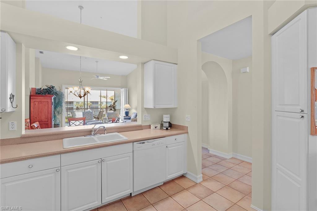 795 Bentwater Circle, Unit 203 Naples, FL 34108 - Photo 12 of 33 a kitchen with a sink and cabinets