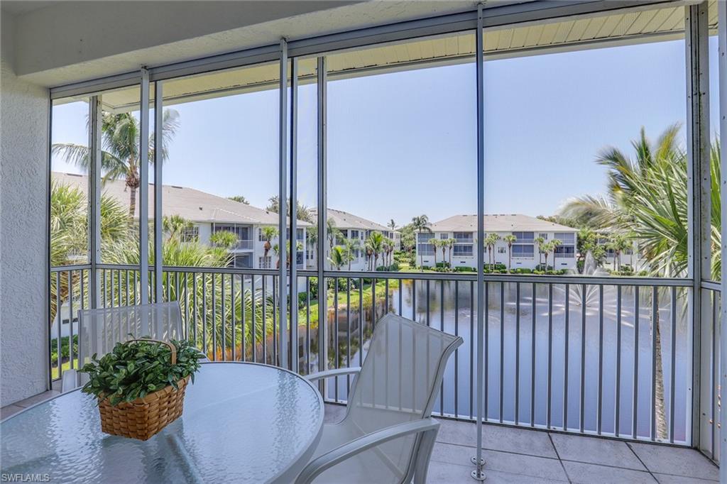 795 Bentwater Circle, Unit 203 Naples, FL 34108 - Photo 20 of 33 a view of a balcony with lake view and a potted plant