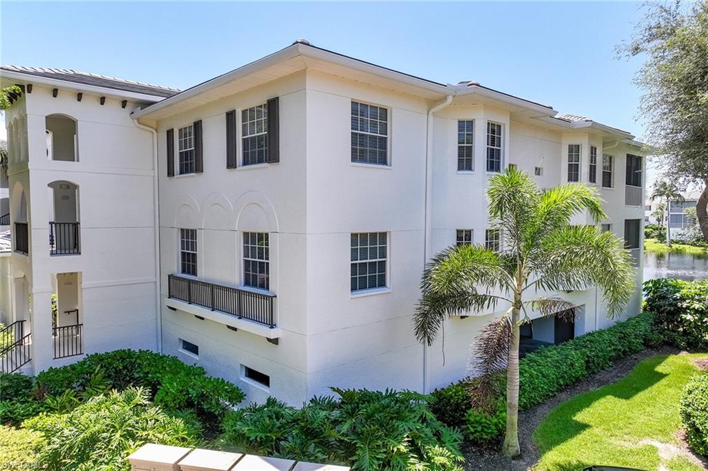 795 Bentwater Circle, Unit 203 Naples, FL 34108 - Photo 2 of 33 a front view of a house with garden