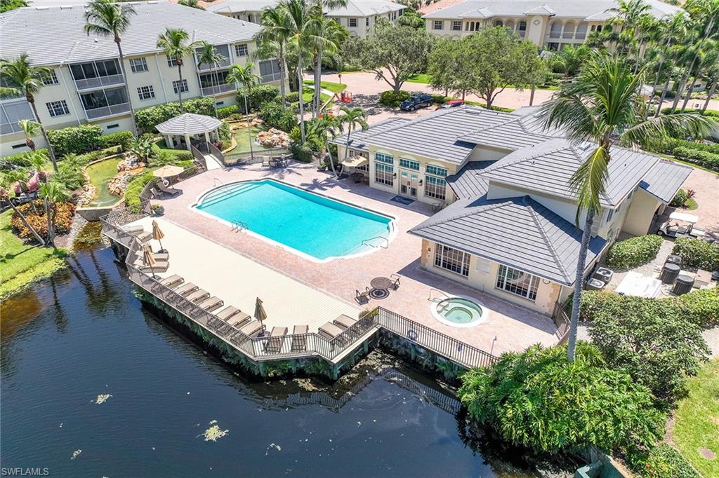 795 Bentwater Circle, Unit 203 Naples, FL 34108 - Photo 28 of 33 an aerial view of a house with a garden and lake view