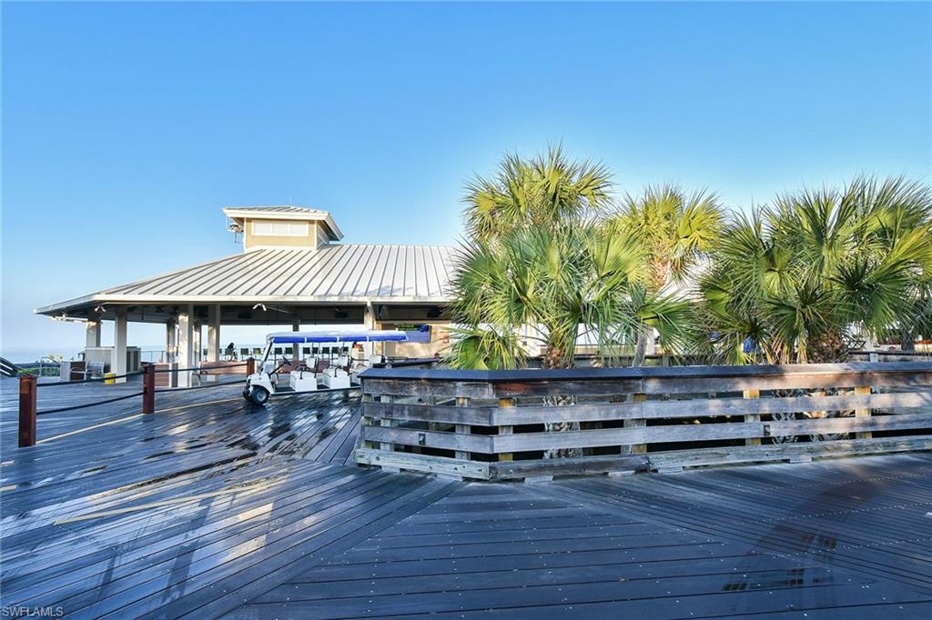 795 Bentwater Circle, Unit 203 Naples, FL 34108 - Photo 31 of 33 a wooden bench sitting in backside of a house
