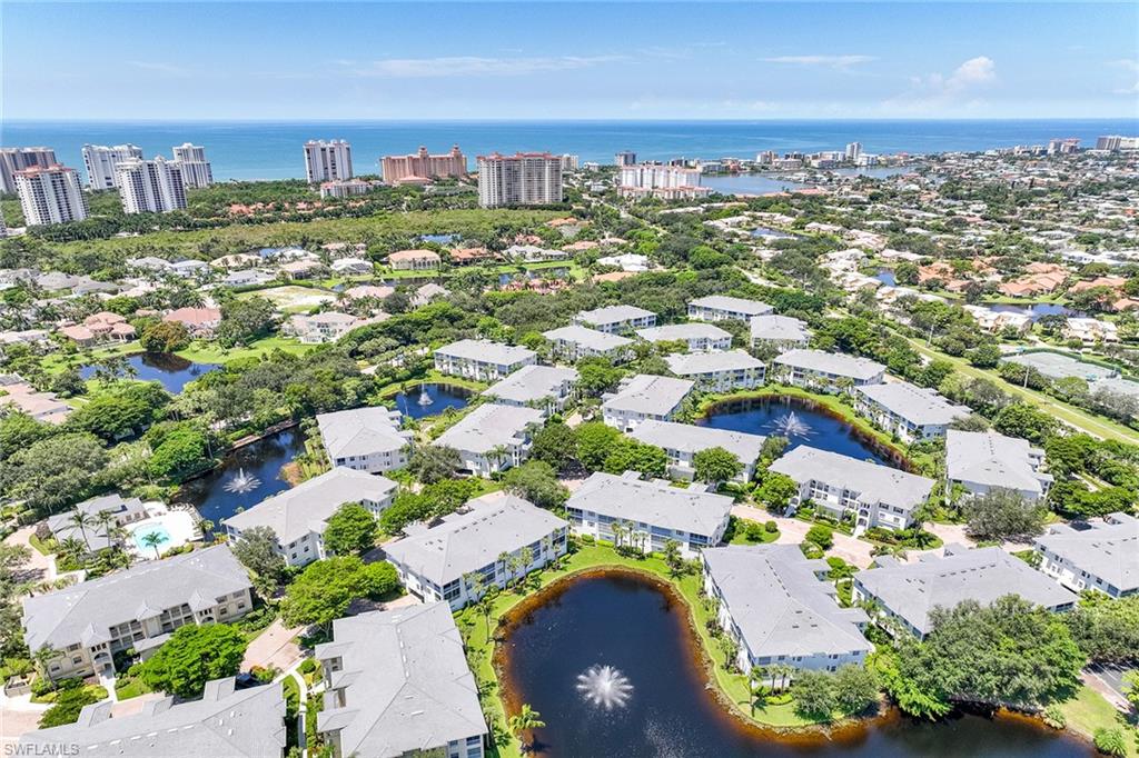 795 Bentwater Circle, Unit 203 Naples, FL 34108 - Photo 4 of 33 an aerial view of residential houses with outdoor space