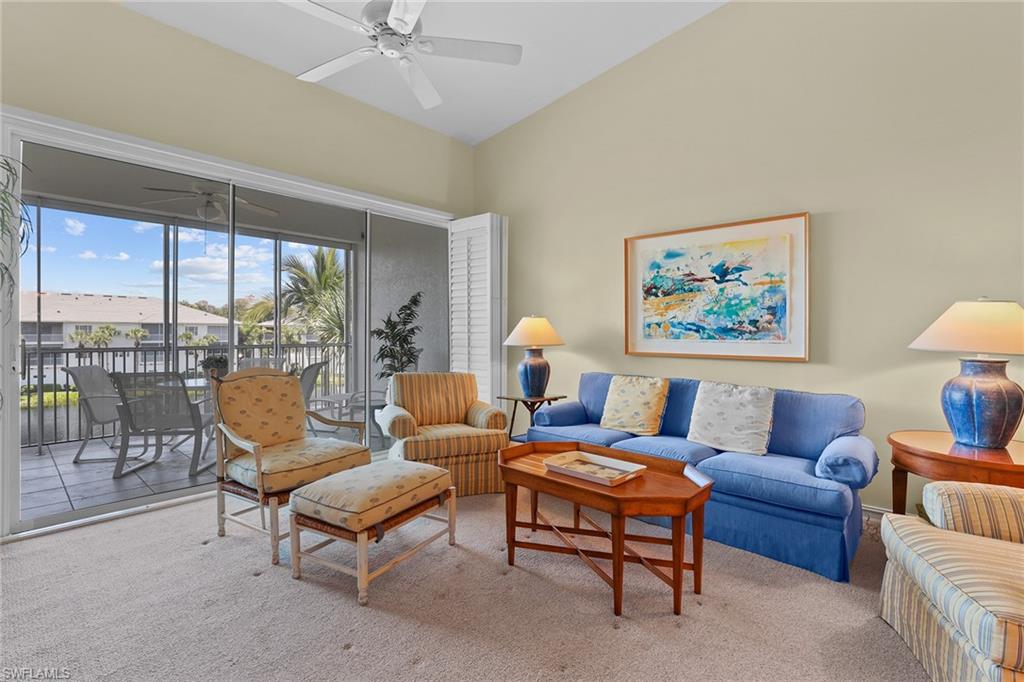 795 Bentwater Circle, Unit 203 Naples, FL 34108 - Photo 6 of 33 a living room with furniture and a large window