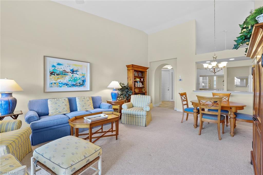 795 Bentwater Circle, Unit 203 Naples, FL 34108 - Photo 7 of 33 a living room with furniture a rug and a lamp