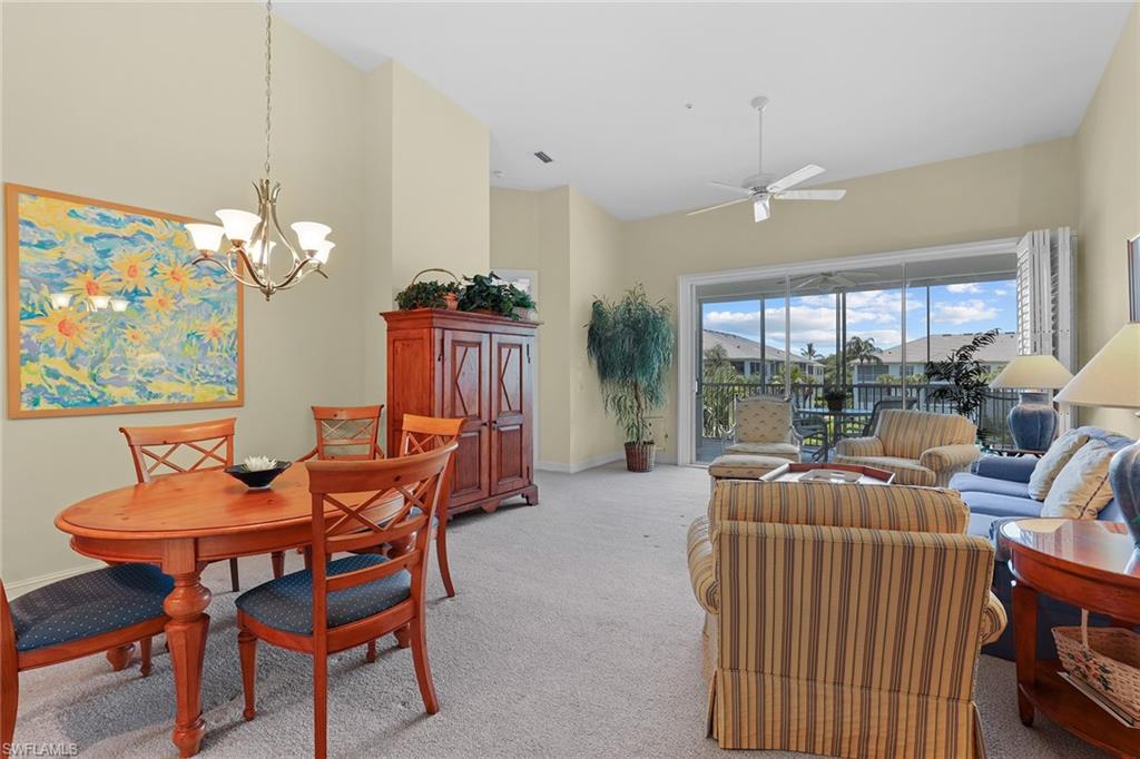795 Bentwater Circle, Unit 203 Naples, FL 34108 - Photo 8 of 33 a dining room with furniture a large window and a chandelier